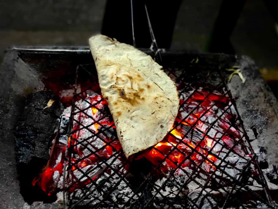 Tlayuda on the coal grill at Libre Tlayudas Dona Martha.Where to eat Oaxaca.