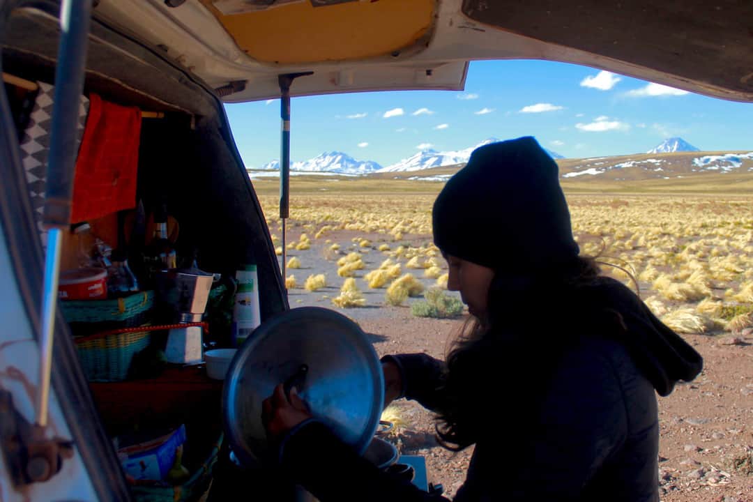 Kelli cooking out the back of the van in the Andes