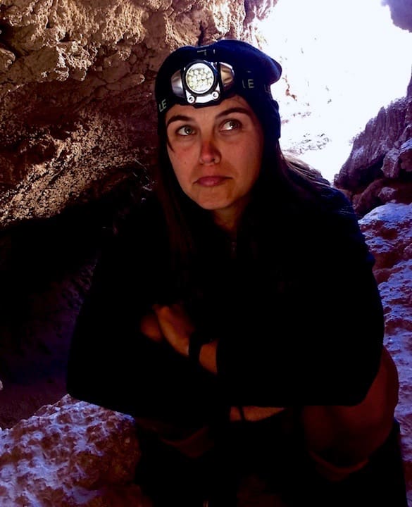 Crouched in a cave in the Valle de la Luna in the Atacama Desert
