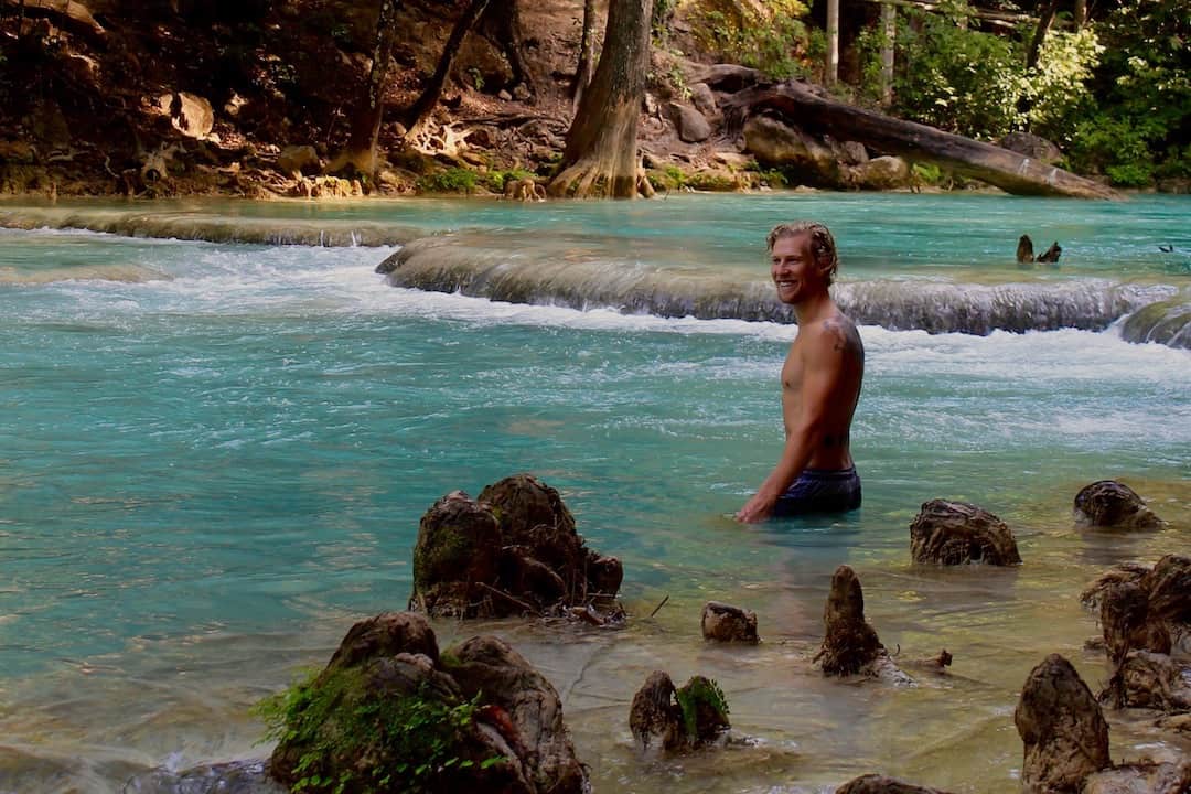 Man bathing in a blue river