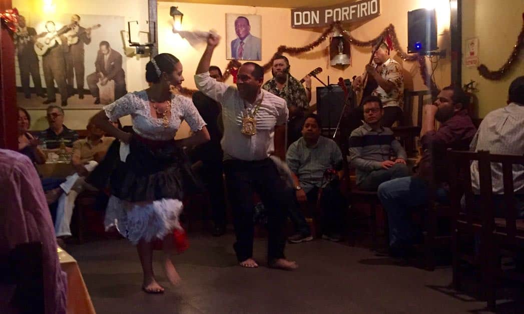 Two Peruvians dancing at the pena of Don Porfirio, one of the best things to see on a one day trip in Lima