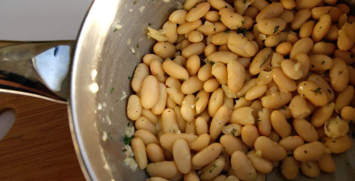 Butter beans in a pot ready to mash