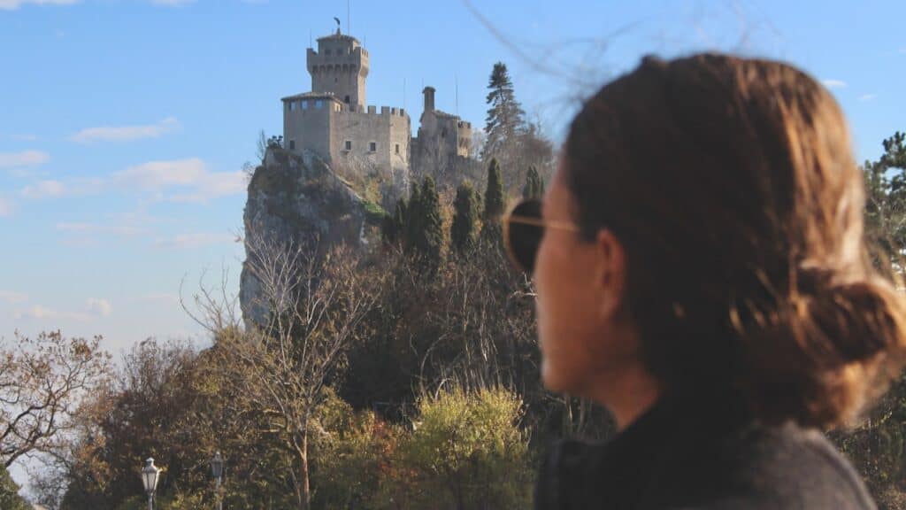 Girl looking at a castle in Italy