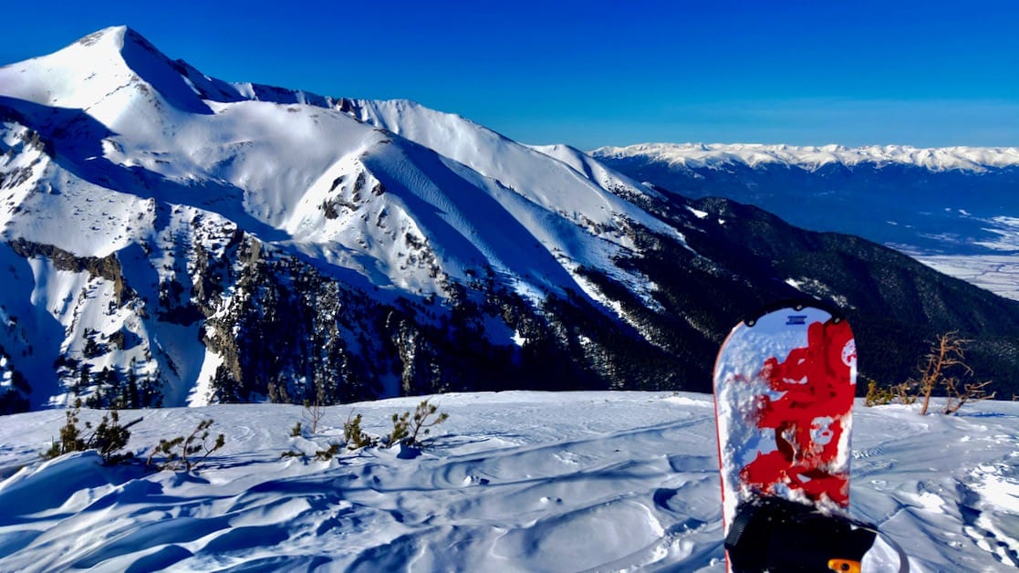 A snowboard in front of a mountain in Bansko