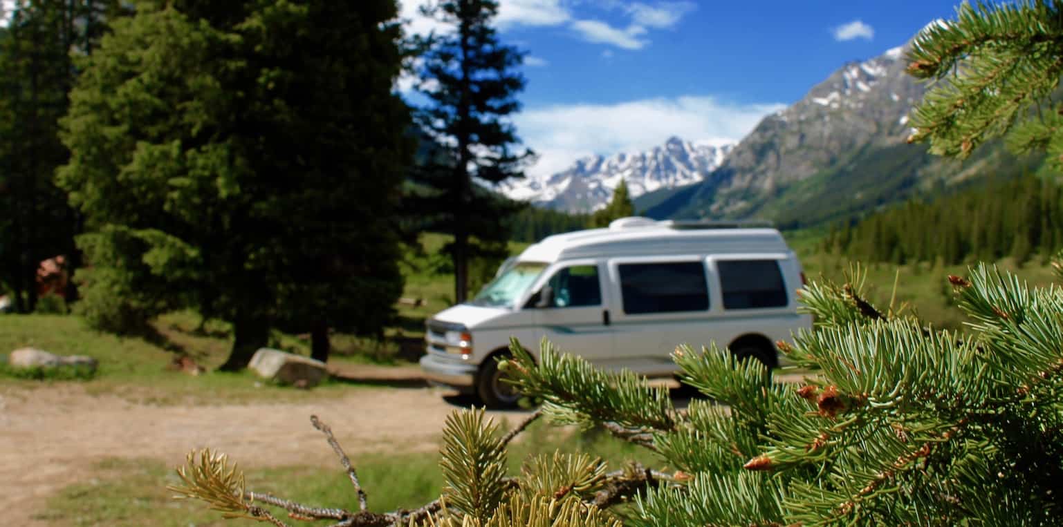Van colorado snow mountains pine trees cover Is Van Life Cheaper Than Renting an Apartment?