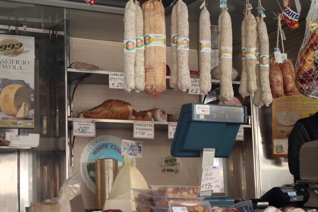 Sausages hanging in a market while campervanning in Italy