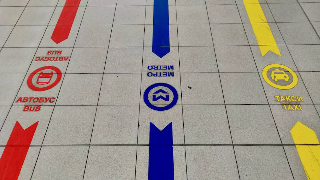 Markings on the floor in the Sofia Airport terminal leading to public and private transport